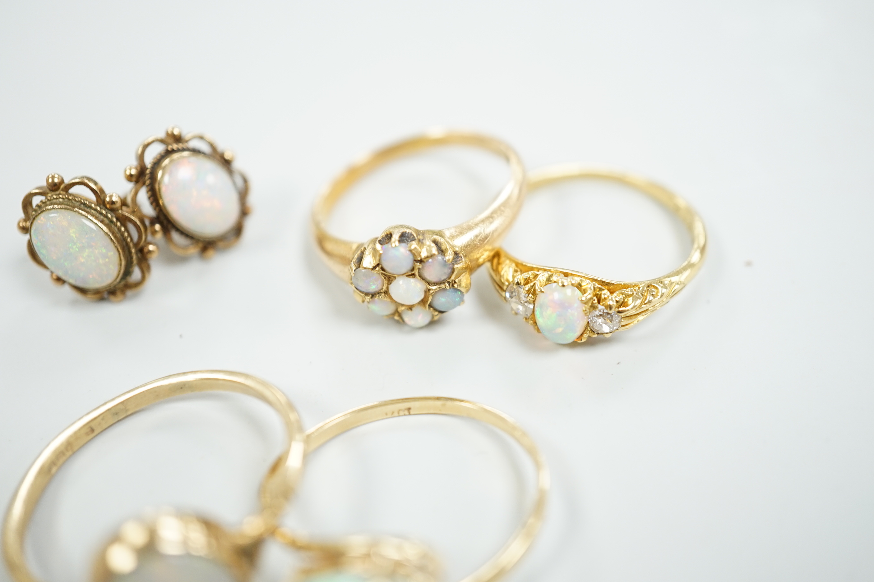 Two 18ct and white opal set rings, one with diamonds, gross 6.2 grams, a 14ct and white opal ring, a 9ct gold and white opal ring and a pair of 9ct gold and white opal earrings.